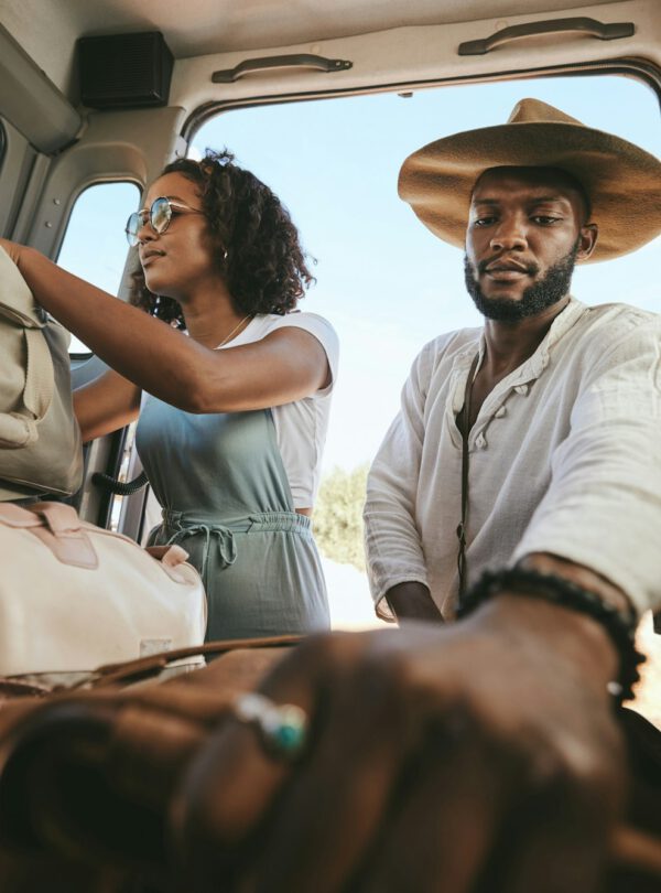 Travel luggage, black couple and car road trip together love bonding on nature safari holiday in Af