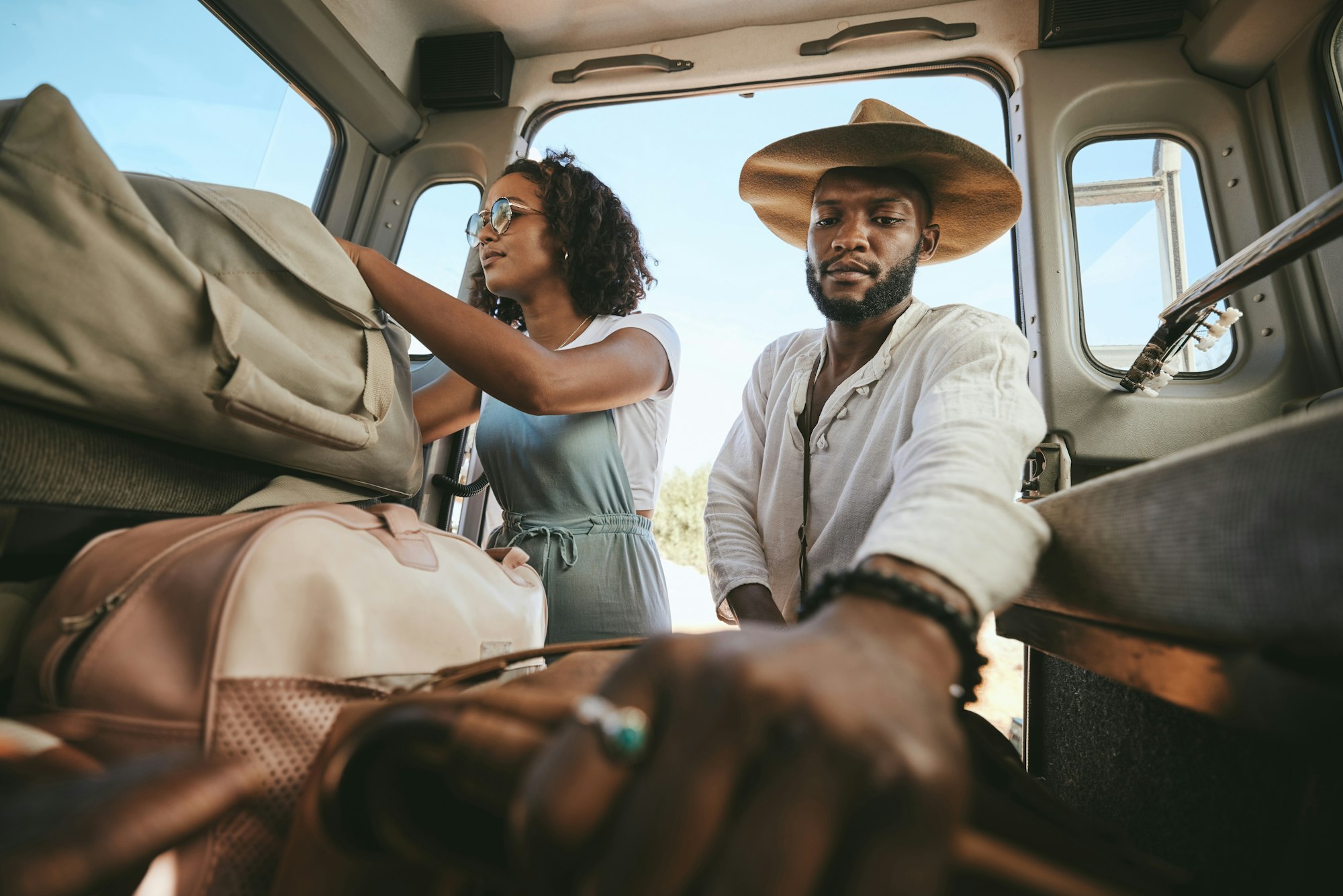 Travel luggage, black couple and car road trip together love bonding on nature safari holiday in Af